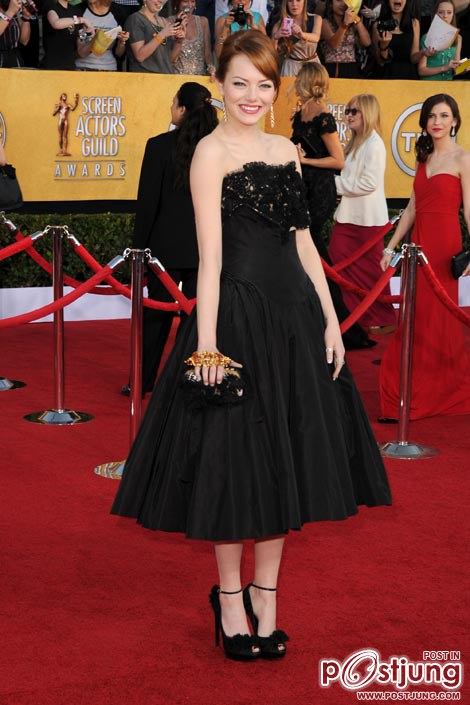 Emma Stone wears an Alexander McQueen dress, shoes