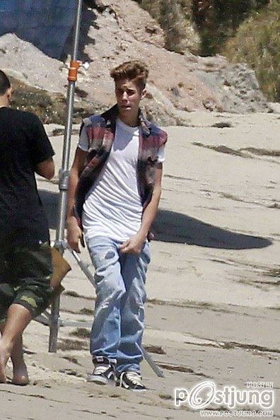 Justin Bieber poses for a photoshoot on the beach in Malibu