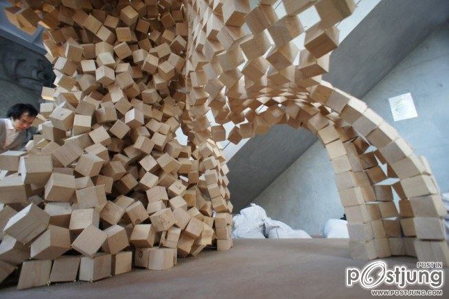 7000 wooden cubes linked together in an inverted question-cube