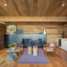 Earthy Timber Clad Interiors vs. Urban Glass Exteriors: Cottage Design by Bates Masi Architects