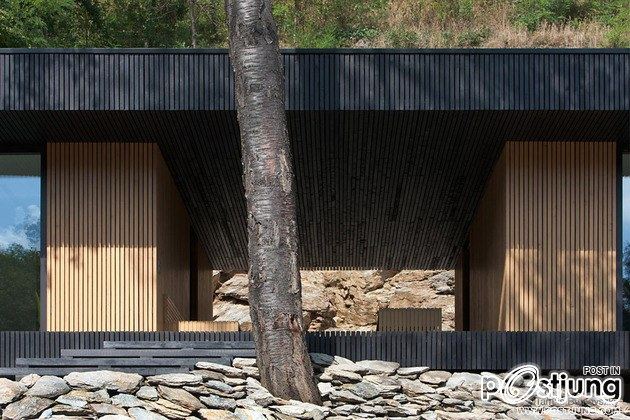 Timber Cabin Built into Cliff Side Site