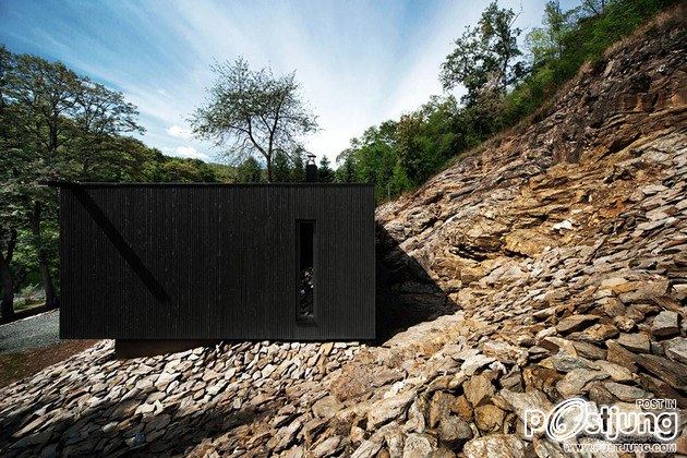 Timber Cabin Built into Cliff Side Site