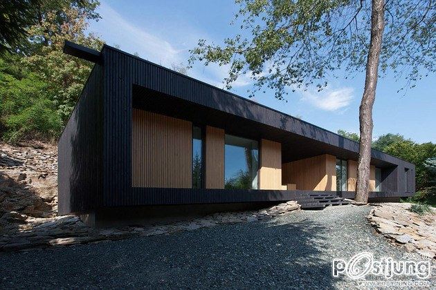 Timber Cabin Built into Cliff Side Site