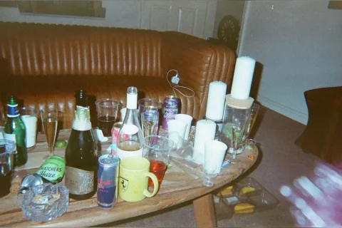 On the sofa , with alcohol from last night&rsquo;s party