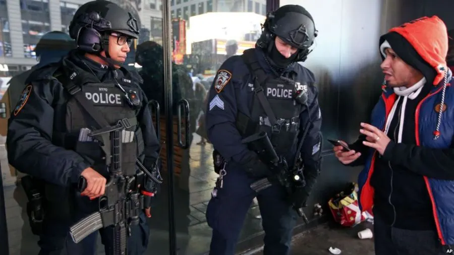 A pedestrian asks directions from two heavily armed counterterrorism officers stationed in Times Square, Thursday, Dec. 29, 2016, in New York. 