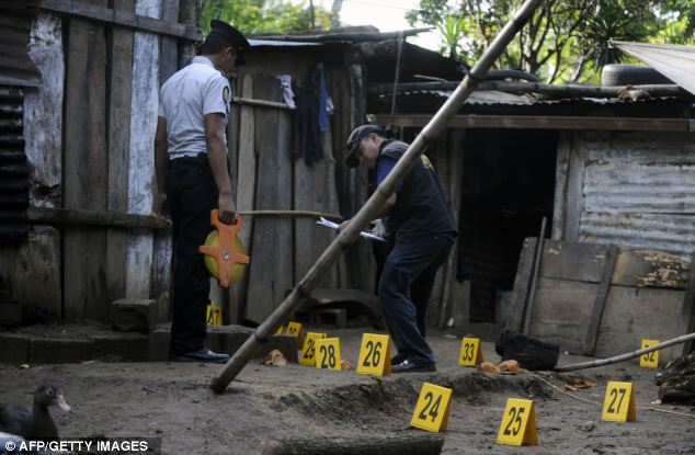 The Guatemalan Public Prosecutor Office investigate the crime scene where seven members of a family, including an eight-months baby and an eight-year old boy, were shot