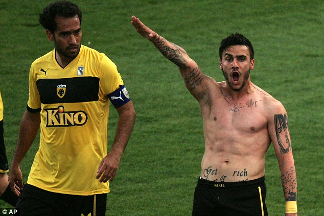 Amazed: Giorgos Katidis's Brazilian-born team-mate Roger Guerreiro (left) looks at him in astonishment