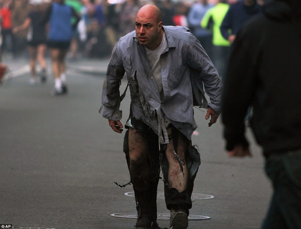เดินได้รับบาดเจ็บ: คนเดินโซเซออกไปจากที่เกิดเหตุระเบิดที่บอสตันมาราธอน 2013 ในบอสตันในวันนี้