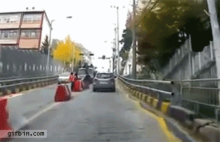 Car avoids out-of-control truck by driving backwards
