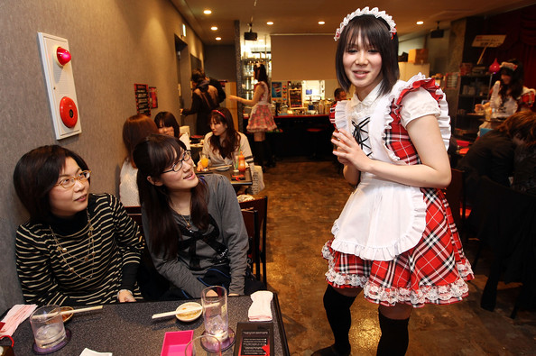 A Male waiter, wearing woman's clothes, serves customers at New Type cafe on February 25, 2010 in Tokyo, Japan. Dressing up in female animation characters by men had been a kind of 