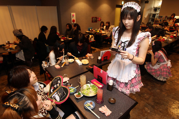 A Male waiter, wearing women's clothes, serves customers at New Type cafe on February 25, 2010 in Tokyo, Japan. Dressing up in female animation characters by men had been a kind of 