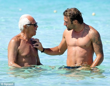 Making a splash: Giorgio Armani hit the beach while enjoying a holiday with a male friend on beautiful Spanish island  Formentera