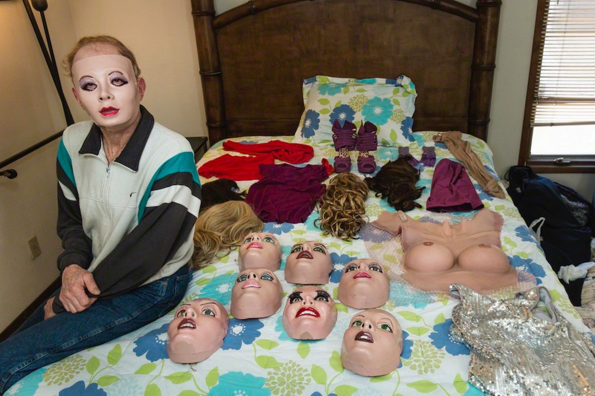 Roby, 70, a real estate agent, seen with his collection of a full length female bodysuit, prosthetic breasts, face masks, wigs and different dresses to look like a 'living doll' in Newport Beach, California. 