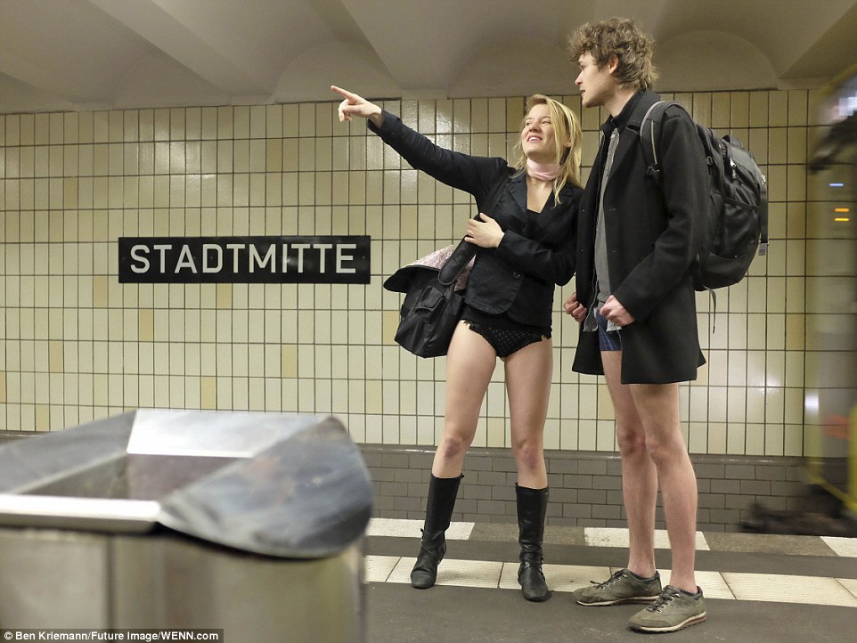 A pair at Stadtmitte in Berlin point to the station signs while taking part in the stunt in Germany 