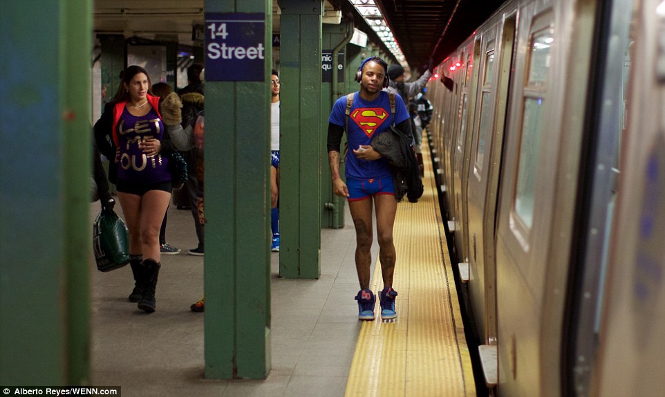 A music fan listening to his headphones bravely dons a Superman t-shirt and matching briefs at 14th Street station in New York 