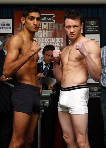 Amir Khan Amir Khan (L) goes face to face with his opponent Oisin Fagan during the lightweight weigh-in at the Grand Plaza hotel, Docklands on December 5, 2008 in London, England.  (Photo by John Gichigi/Getty Images) *** Local Caption *** Amir Khan;Oisin Fagan