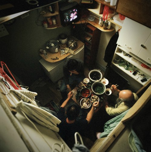 Former-residents of 81 Bowery cook and eat together in their tiny cubicles. | Credit: Annie Ling