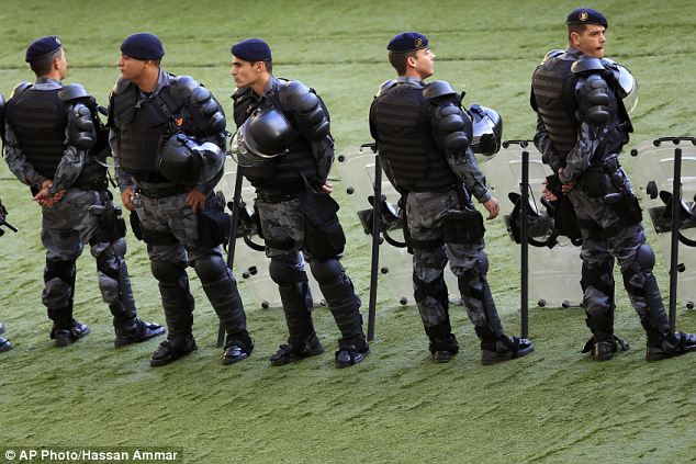 Policemen stand guard inside the Maracana stadium: World Cup travellers have been given fresh warnings over safety in Brazil, as the country's civil police staged a one-day walkout over pay