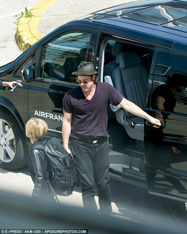 Come on! Brad opened the door of the large Air France car for his kids and wife to take an onward journey