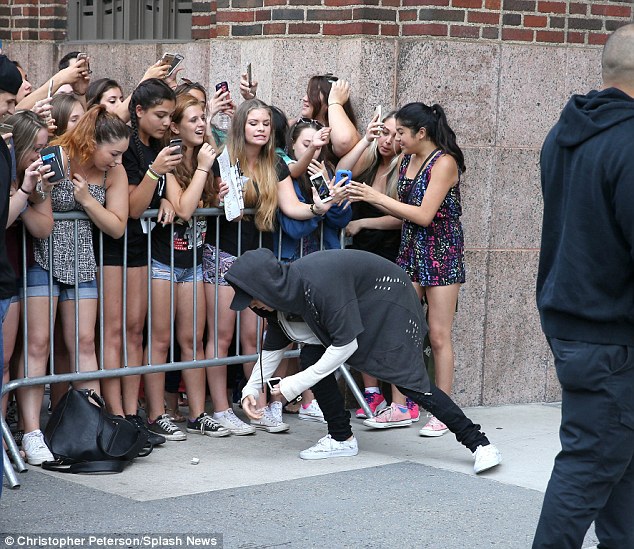 After dropping a fan's phone: Justin appeared to look apologetic as he picked up the device off the ground and returned it to the rightful owner