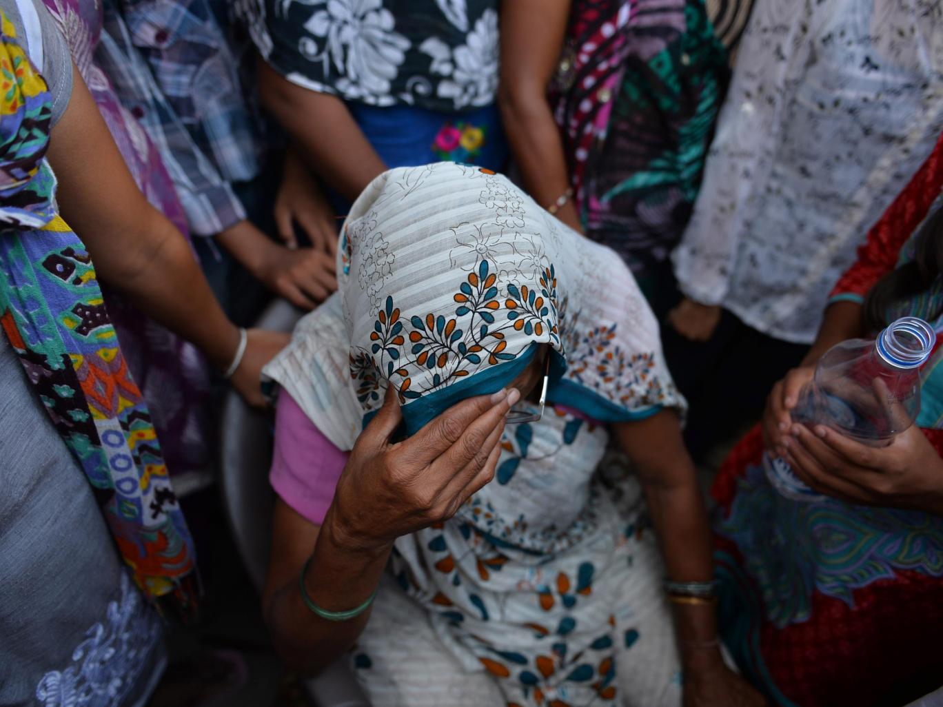 Grandmother of Indian minor girl who was raped sits among protesters