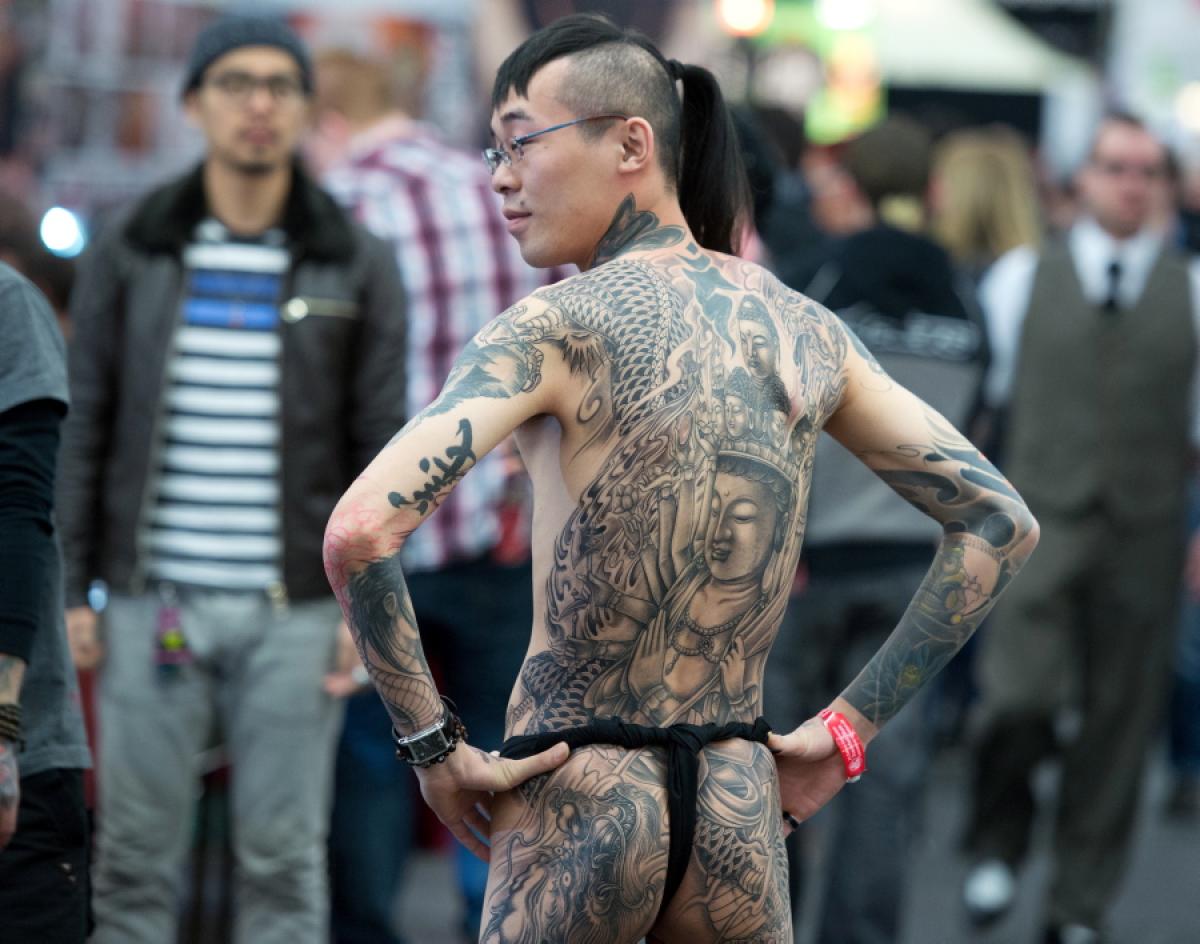 A young man shows his tattoos at the International Tattoo Convention in Frankfurt am Main, Germany on March 23, 2013.