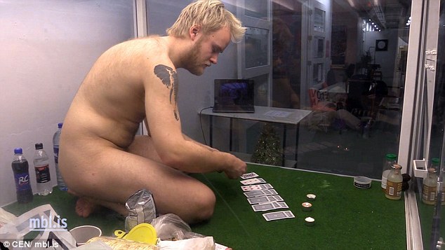 Mr Atlason plays cards by himself as he passes the time at the Iceland Academy of Arts, Reykjavik